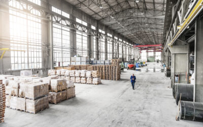 Manager walking through factory warehouse